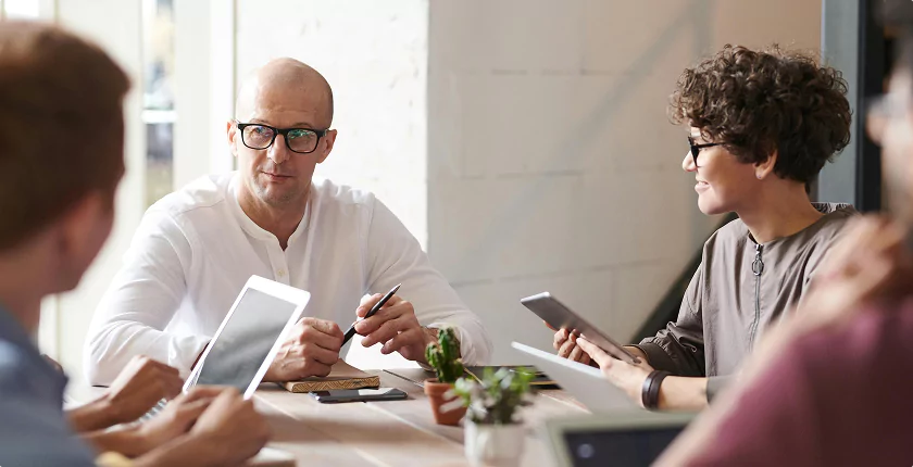 Team discussing strategy in a casual office setting.